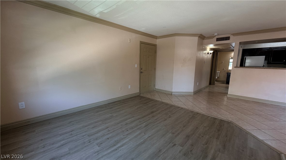 8101 West Flamingo Road, Unit 1082 Las Vegas, NV 89147 - Photo 9 of 23 A welcoming entryway transitions seamlessly into an open-concept living space, featuring mixed flooring.