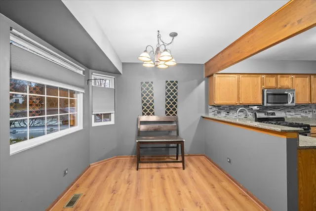 a view of a room with wooden floor and window