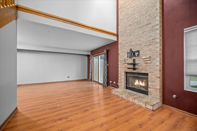 a view of an empty room with fire place and a fireplace