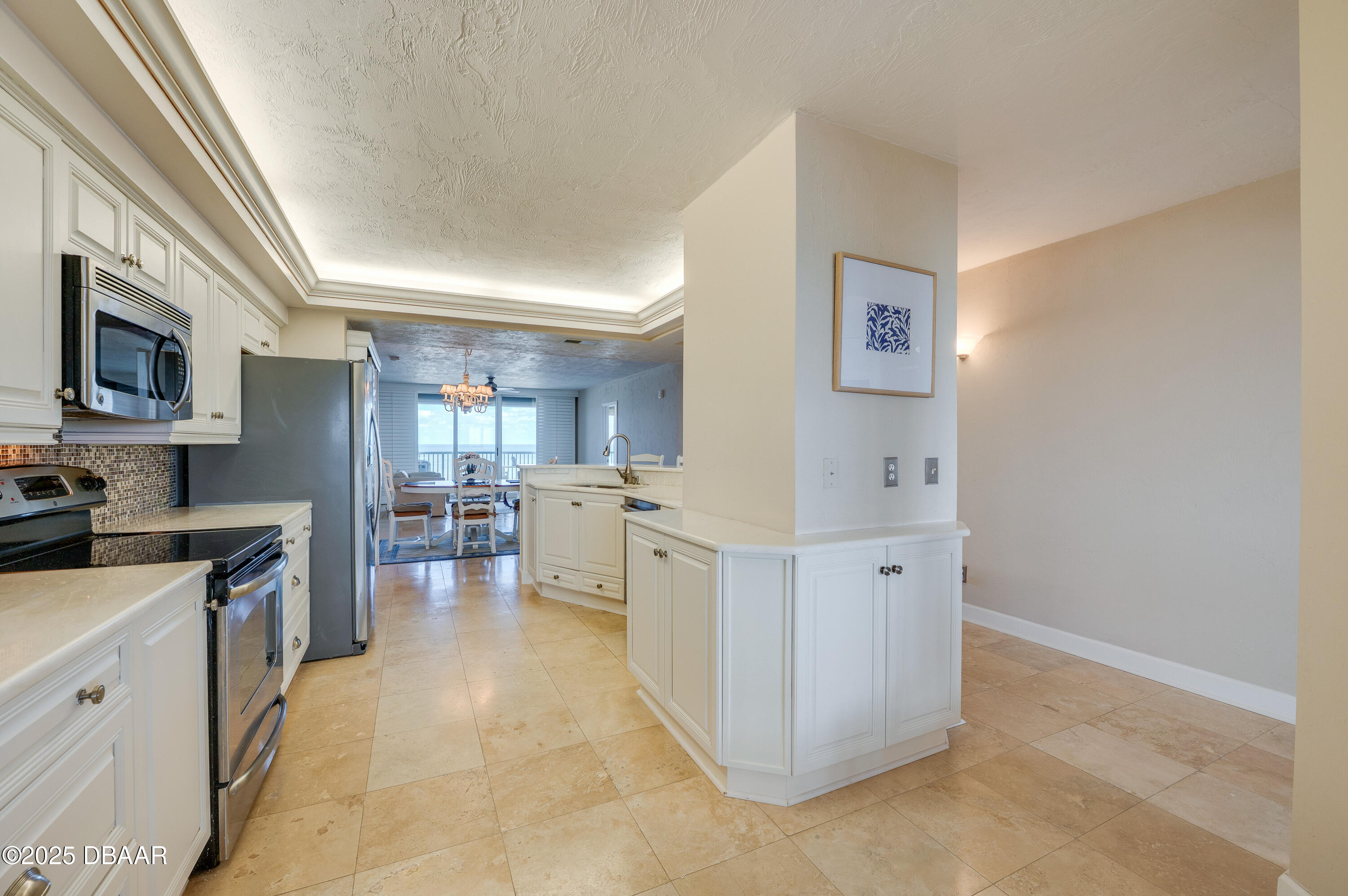 4525 South Atlantic Avenue, Unit 1704 Ponce Inlet, FL 32127 - Photo 12 of 45 a kitchen with cabinets and wooden floor