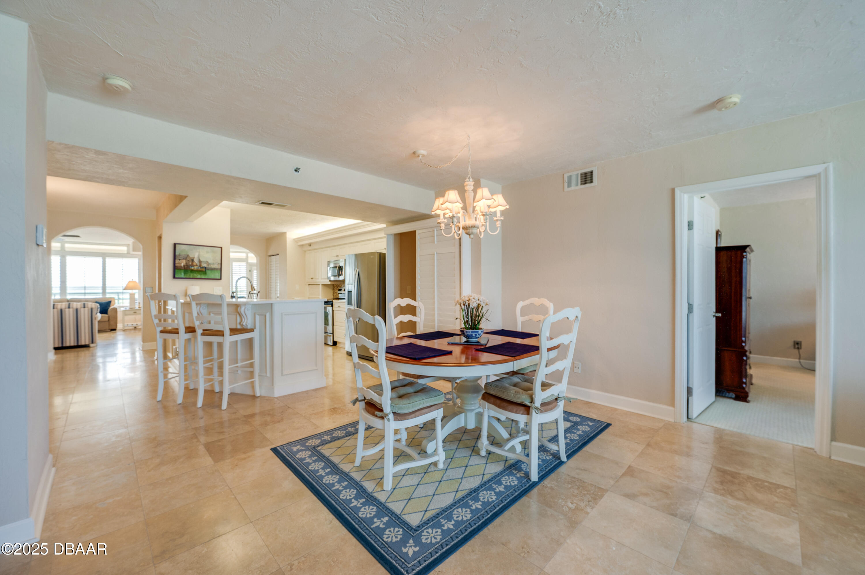 4525 South Atlantic Avenue, Unit 1704 Ponce Inlet, FL 32127 - Photo 17 of 45 a dining room with furniture and chandelier