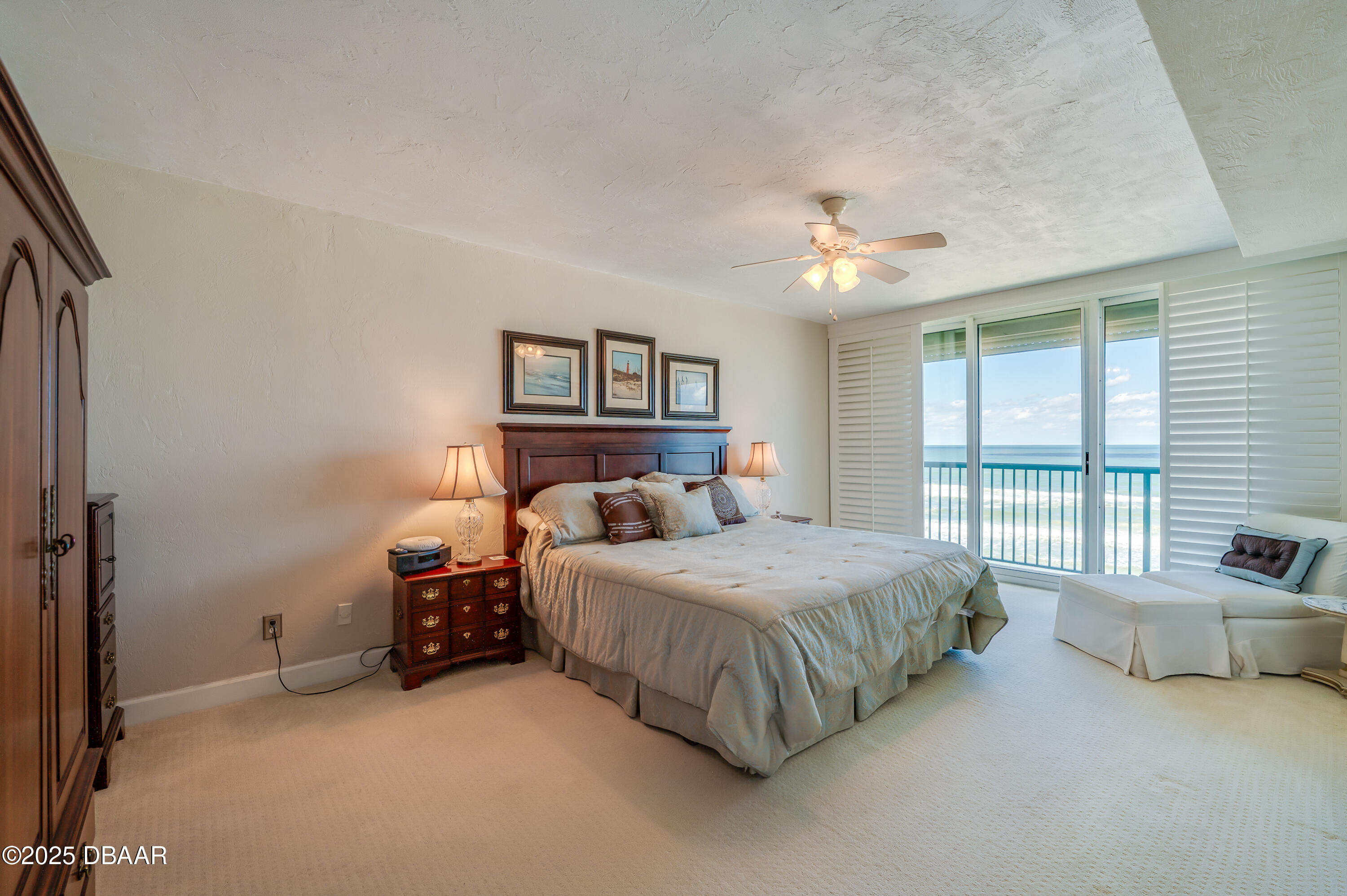 4525 South Atlantic Avenue, Unit 1704 Ponce Inlet, FL 32127 - Photo 20 of 45 a bedroom with a bed and a couch next to a window