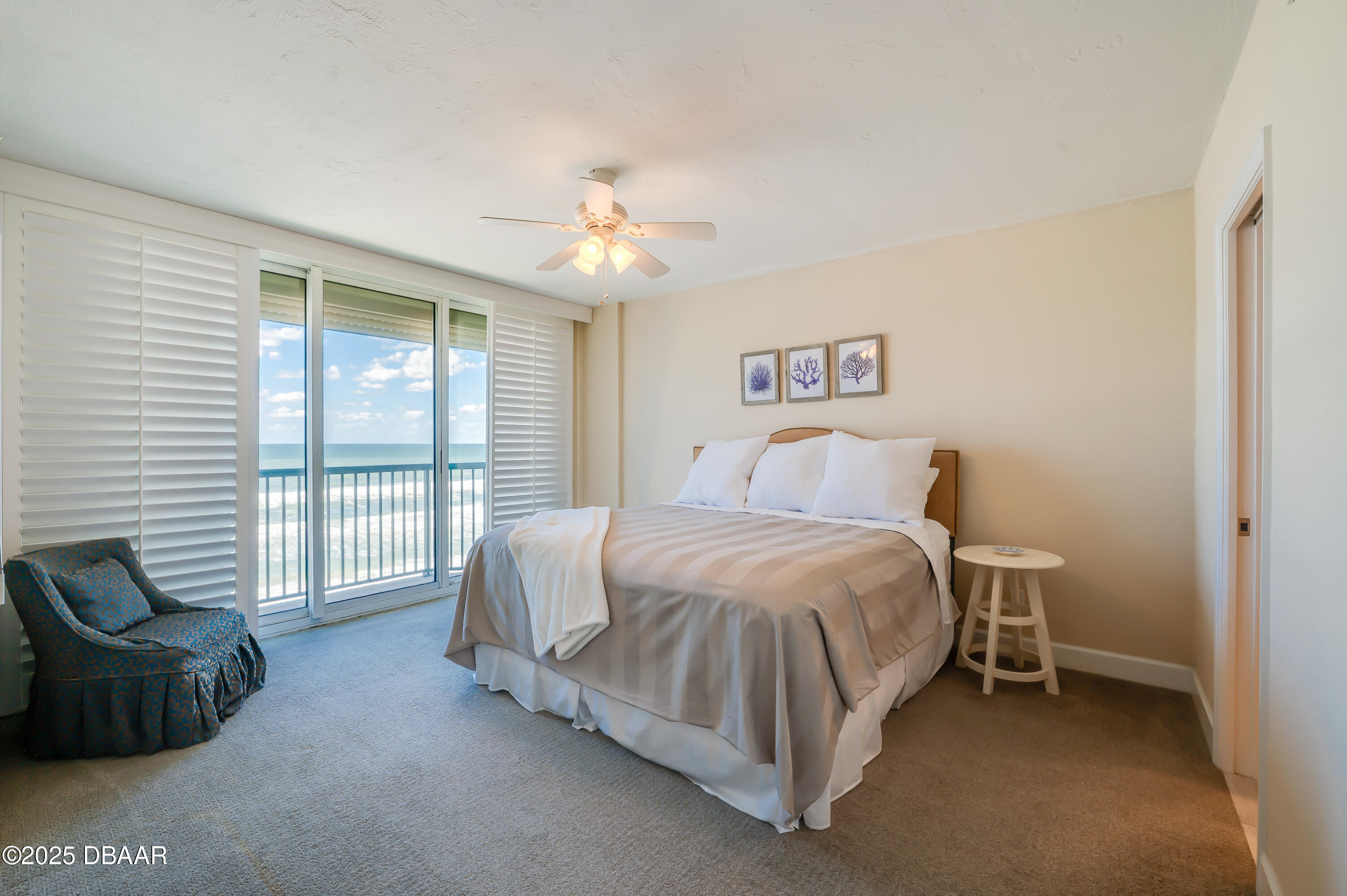 4525 South Atlantic Avenue, Unit 1704 Ponce Inlet, FL 32127 - Photo 26 of 45 a spacious bedroom with a bed and a large window