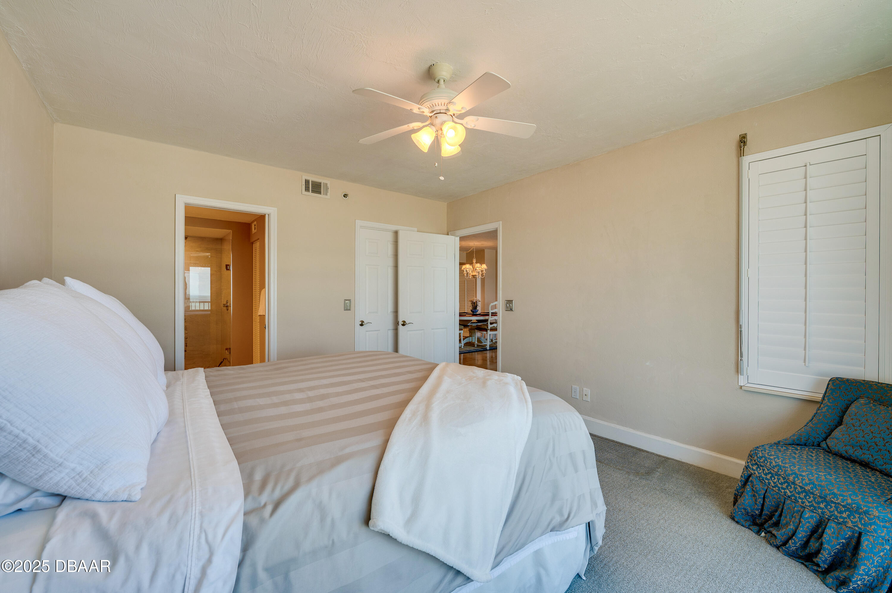 4525 South Atlantic Avenue, Unit 1704 Ponce Inlet, FL 32127 - Photo 27 of 45 a bedroom with a bed and ceiling fan