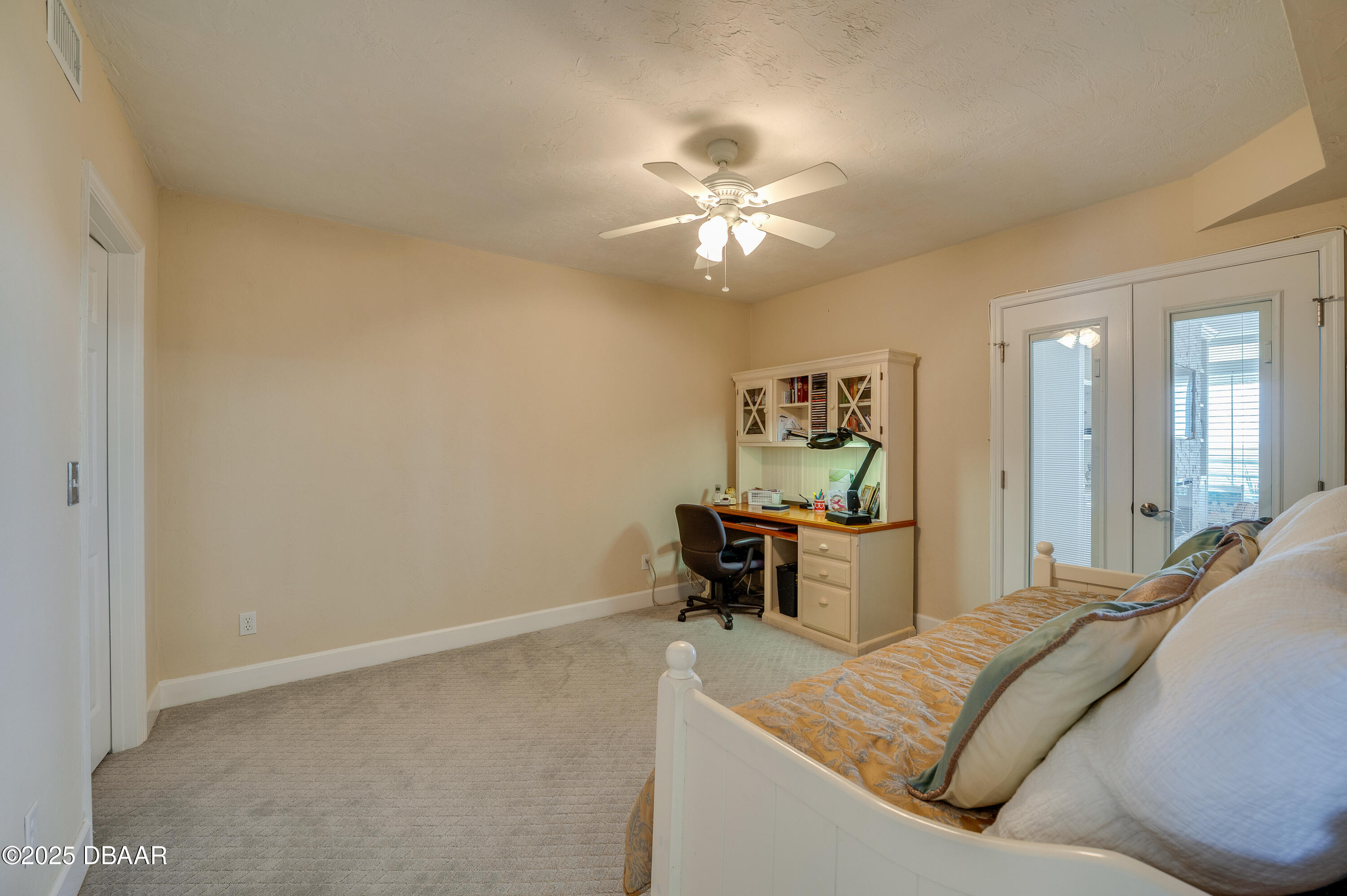 4525 South Atlantic Avenue, Unit 1704 Ponce Inlet, FL 32127 - Photo 29 of 45 a living room with a couch and a chandelier
