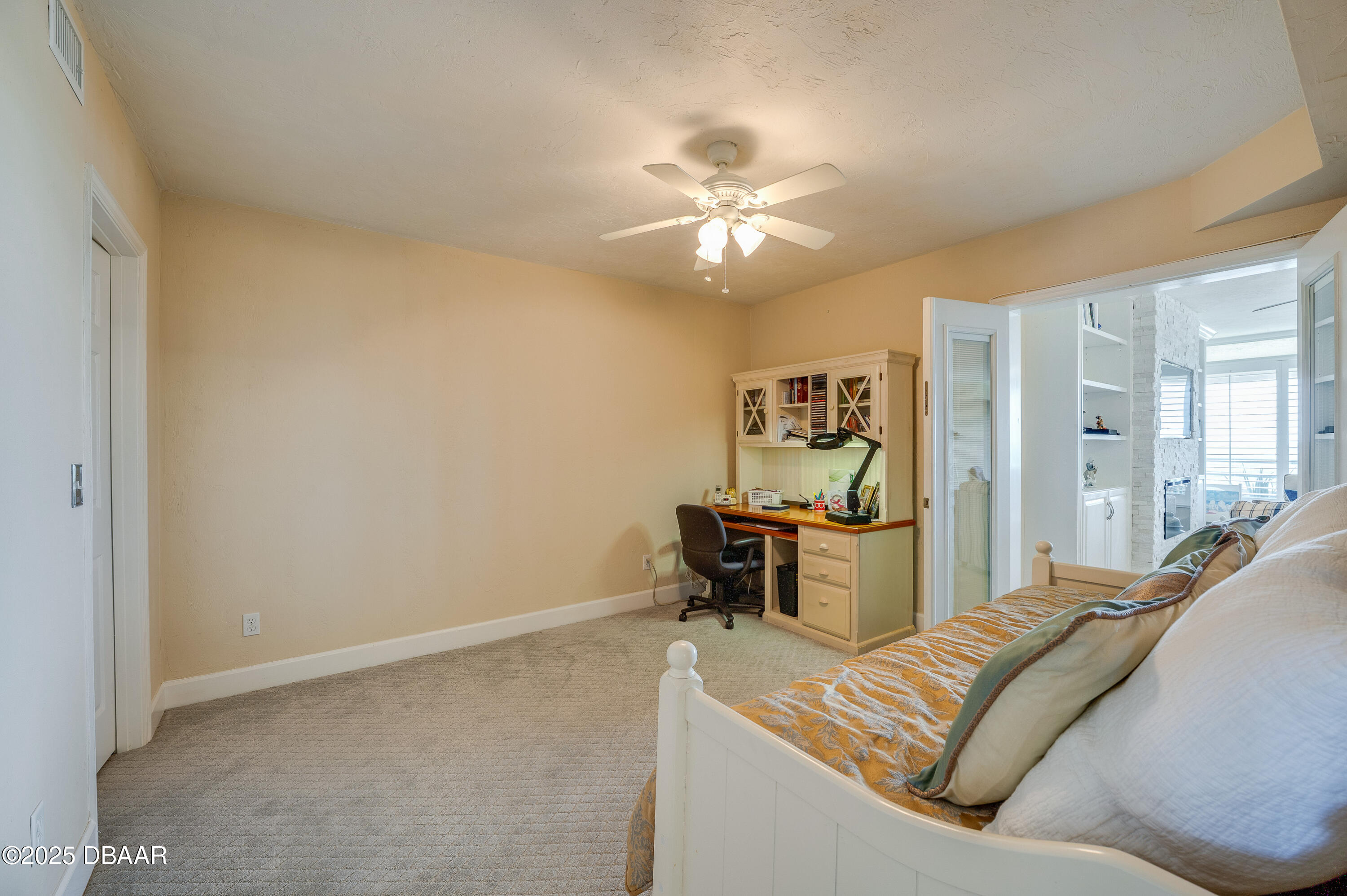 4525 South Atlantic Avenue, Unit 1704 Ponce Inlet, FL 32127 - Photo 30 of 45 a living room with a couch and a chandelier
