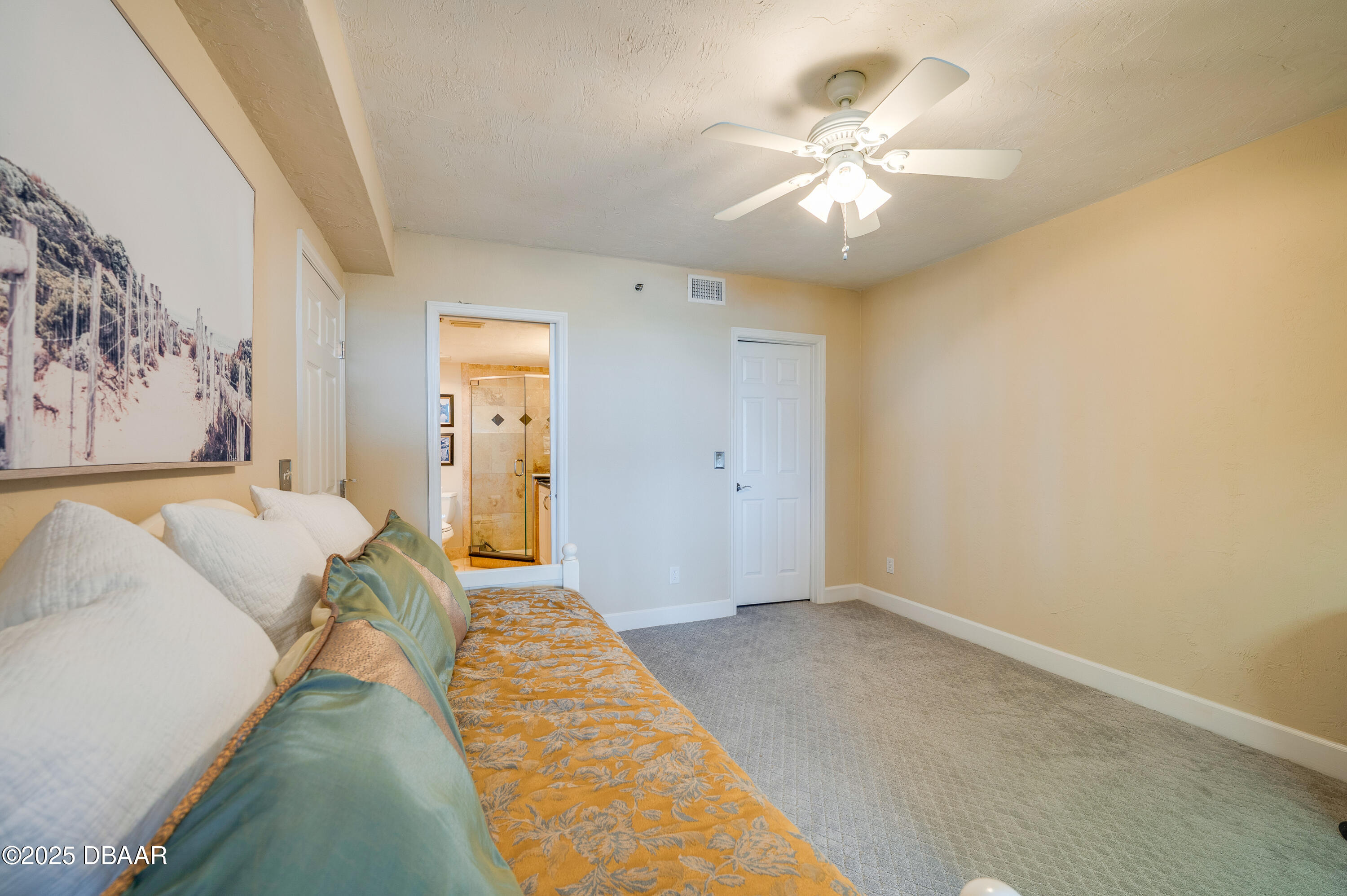 4525 South Atlantic Avenue, Unit 1704 Ponce Inlet, FL 32127 - Photo 31 of 45 a bed room with a bed and a chandelier