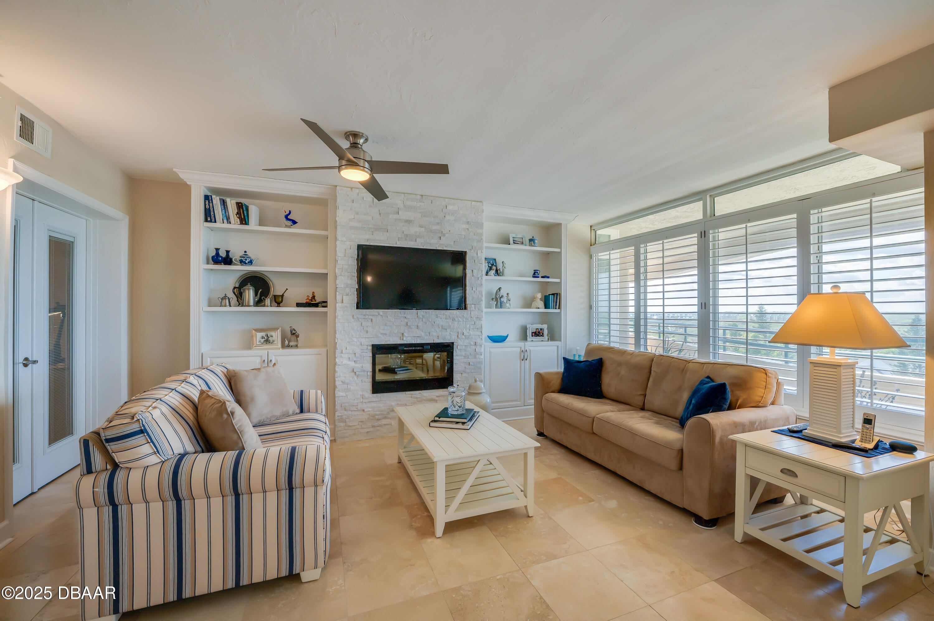 4525 South Atlantic Avenue, Unit 1704 Ponce Inlet, FL 32127 - Photo 4 of 45 a living room with furniture and a flat screen tv