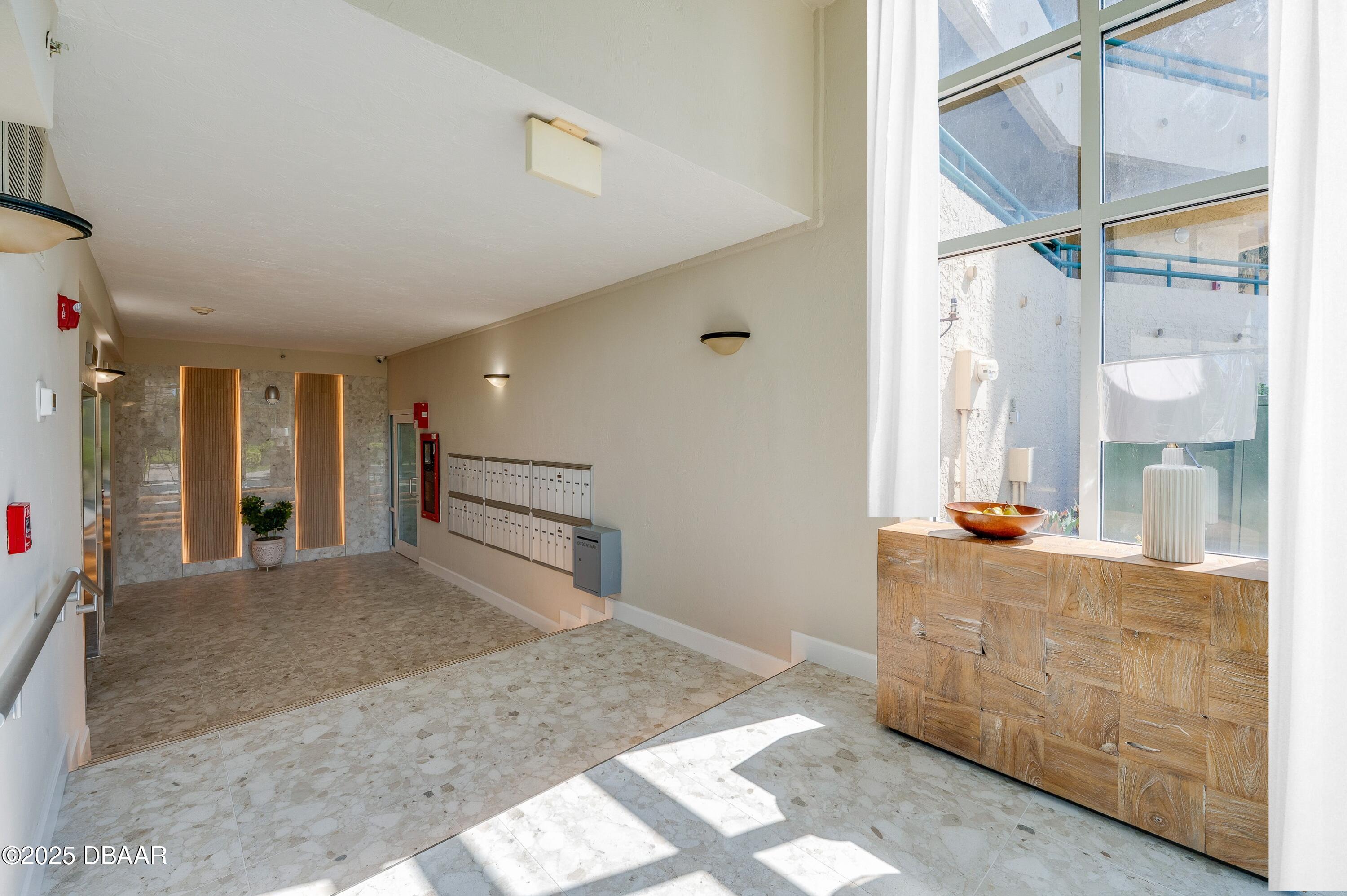 4525 South Atlantic Avenue, Unit 1704 Ponce Inlet, FL 32127 - Photo 42 of 45 a view of a hallway to dining room with wooden floor and windows