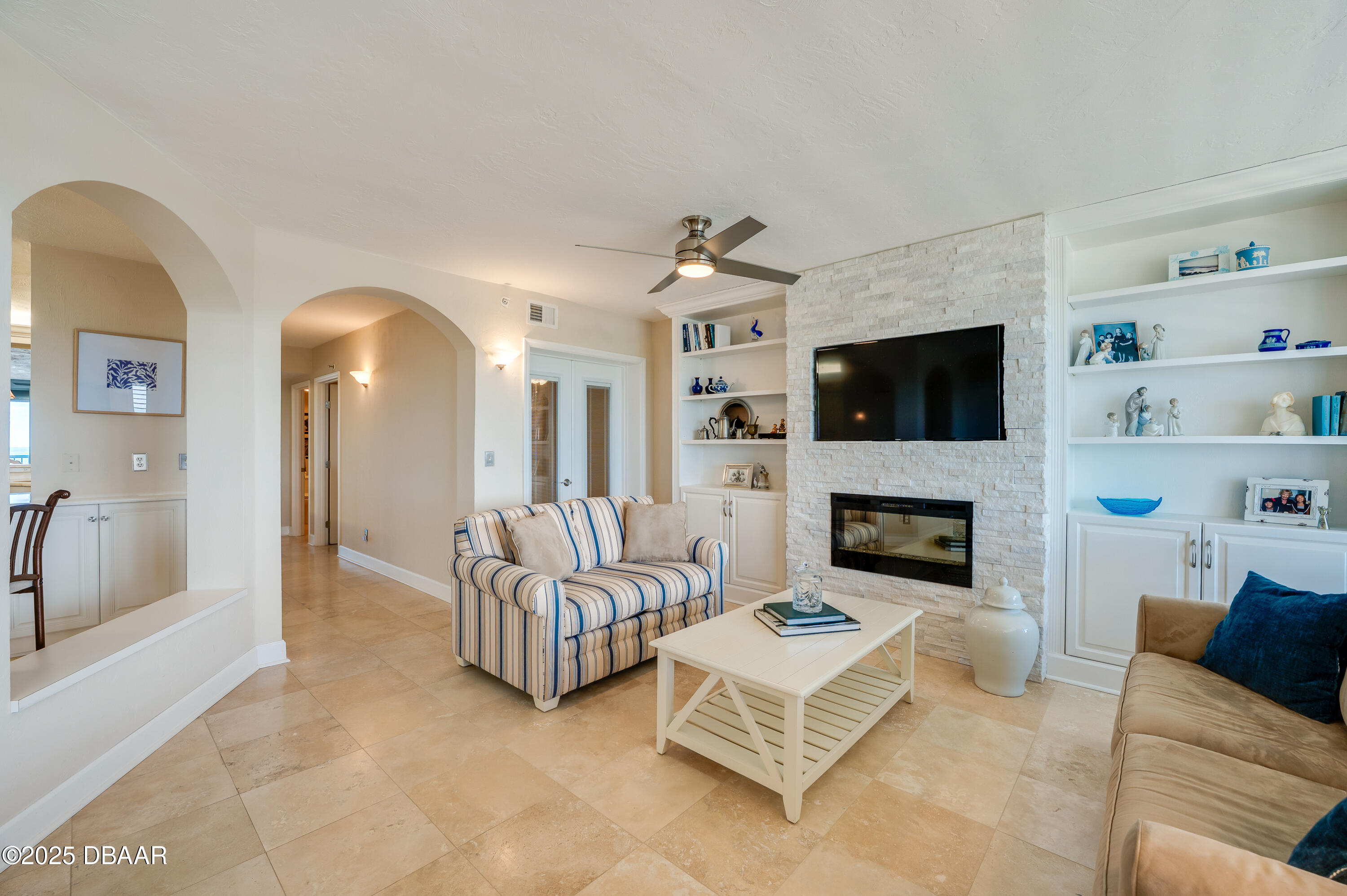 4525 South Atlantic Avenue, Unit 1704 Ponce Inlet, FL 32127 - Photo 5 of 45 a living room with furniture and a fireplace