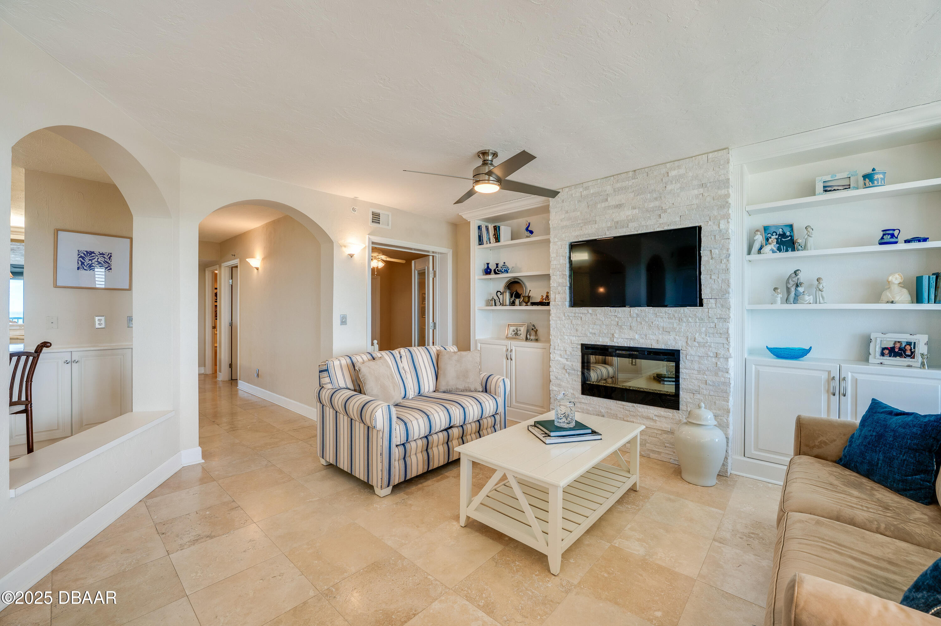4525 South Atlantic Avenue, Unit 1704 Ponce Inlet, FL 32127 - Photo 6 of 45 a living room with furniture and a fireplace