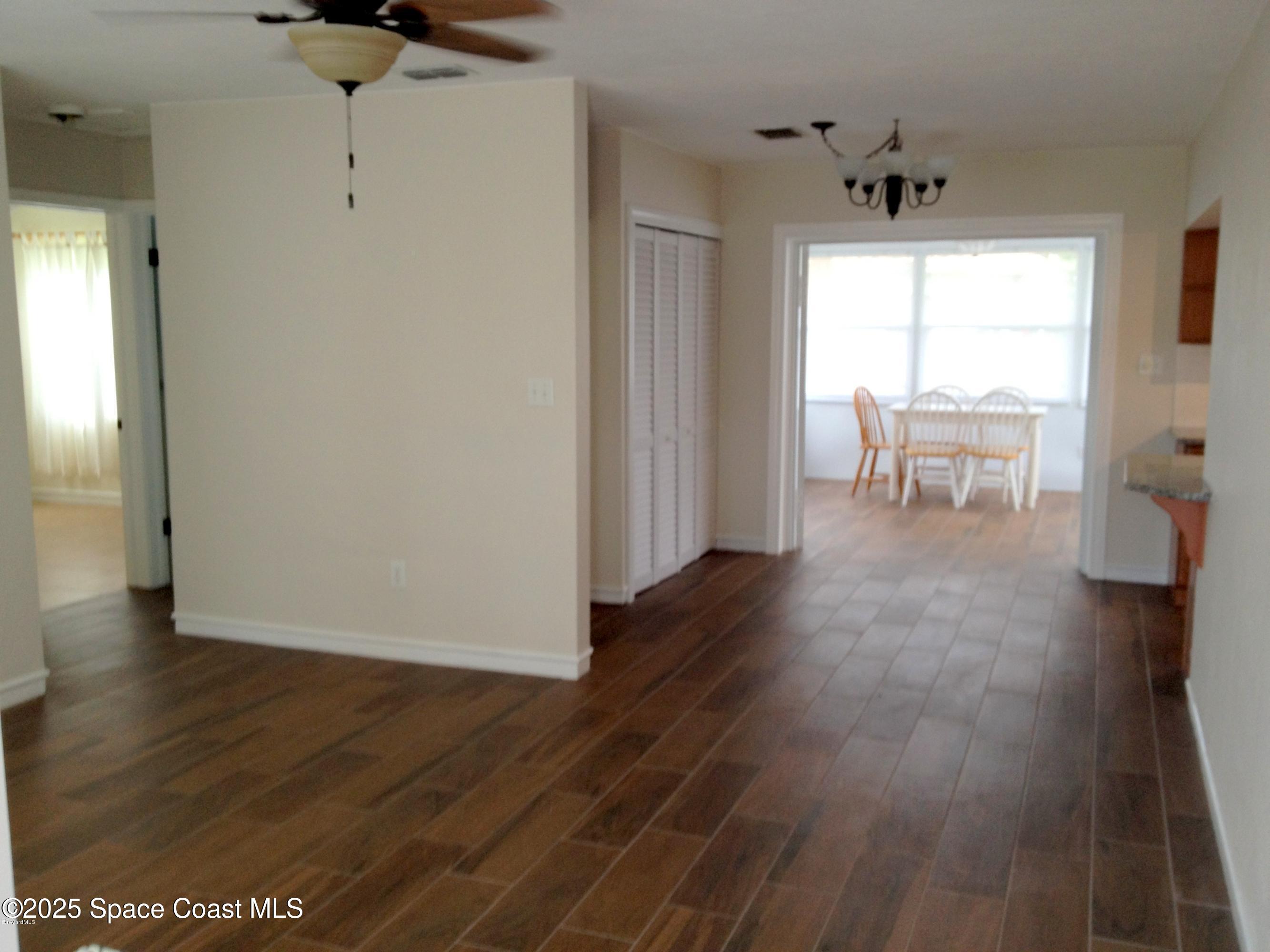 151 Delmar Street Indialantic, FL 32903 - Photo 4 of 6 a view of an empty room with wooden floor and a window