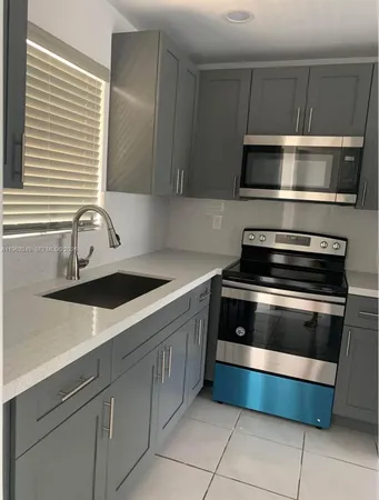 a kitchen with a sink and a microwave