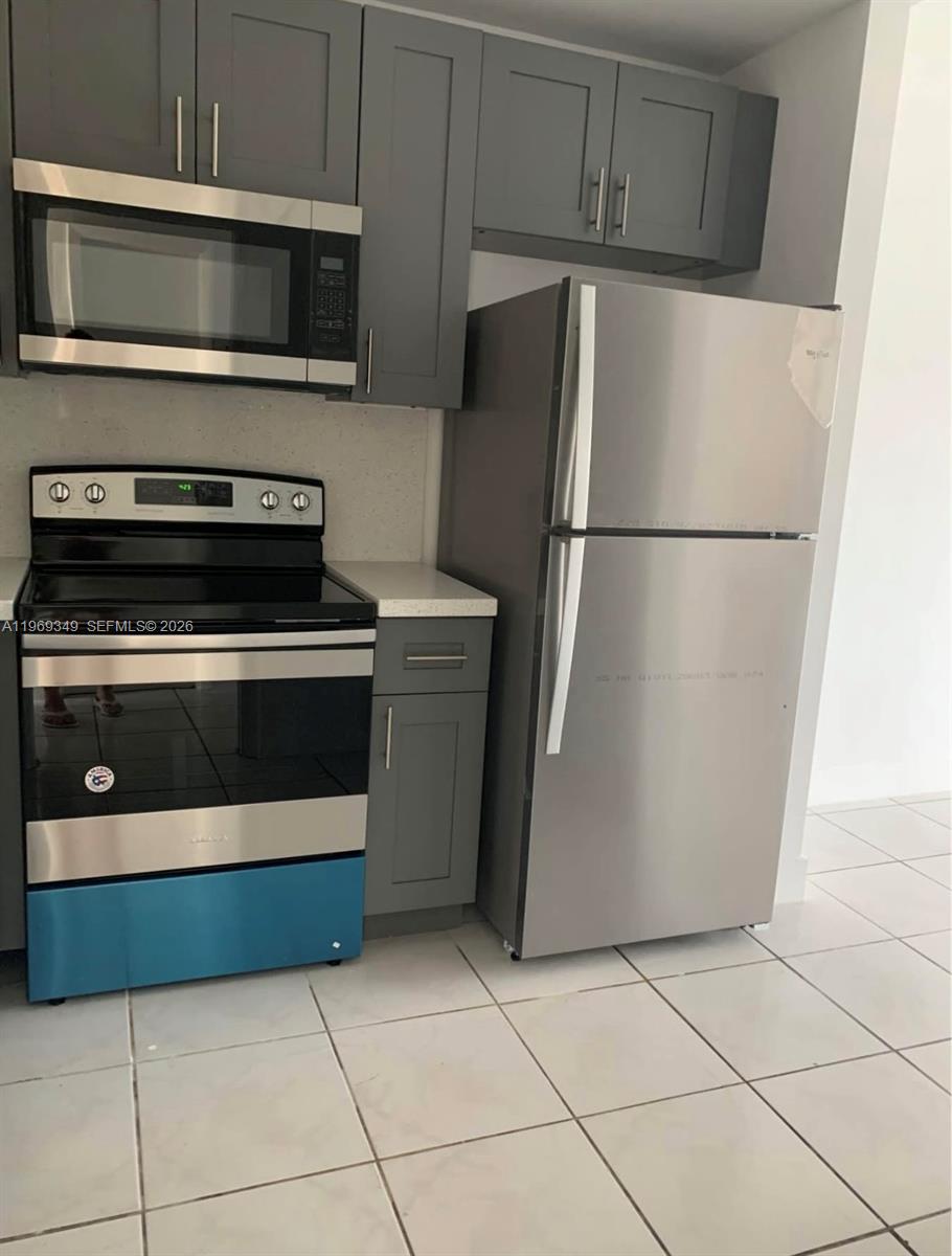 7505 Southwest 82nd Street, Unit 306 Miami, FL 33143 - Photo 2 of 9 a kitchen with cabinets and stainless steel appliances