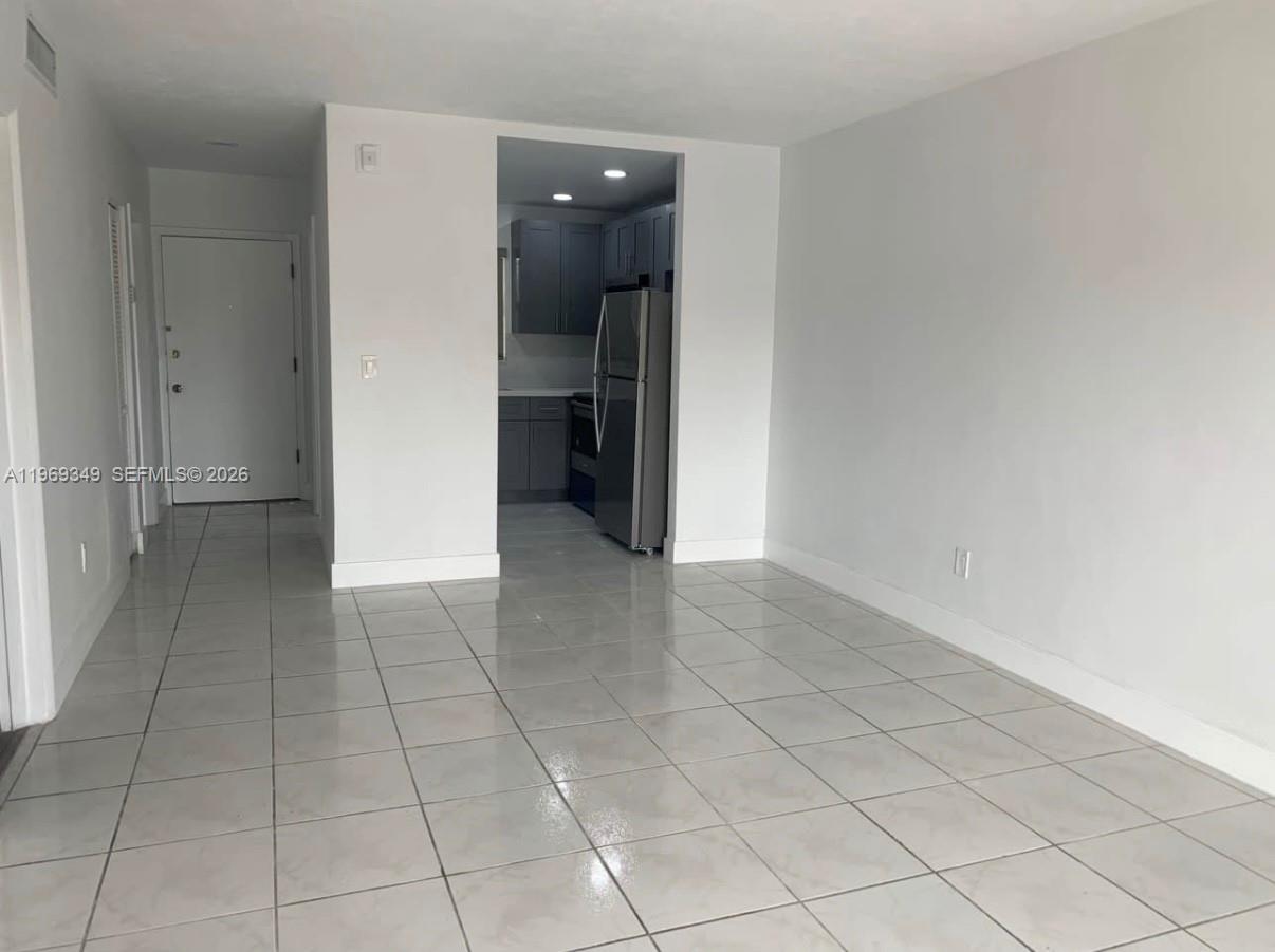 7505 Southwest 82nd Street, Unit 306 Miami, FL 33143 - Photo 3 of 9 an empty room with a bathroom and a sink