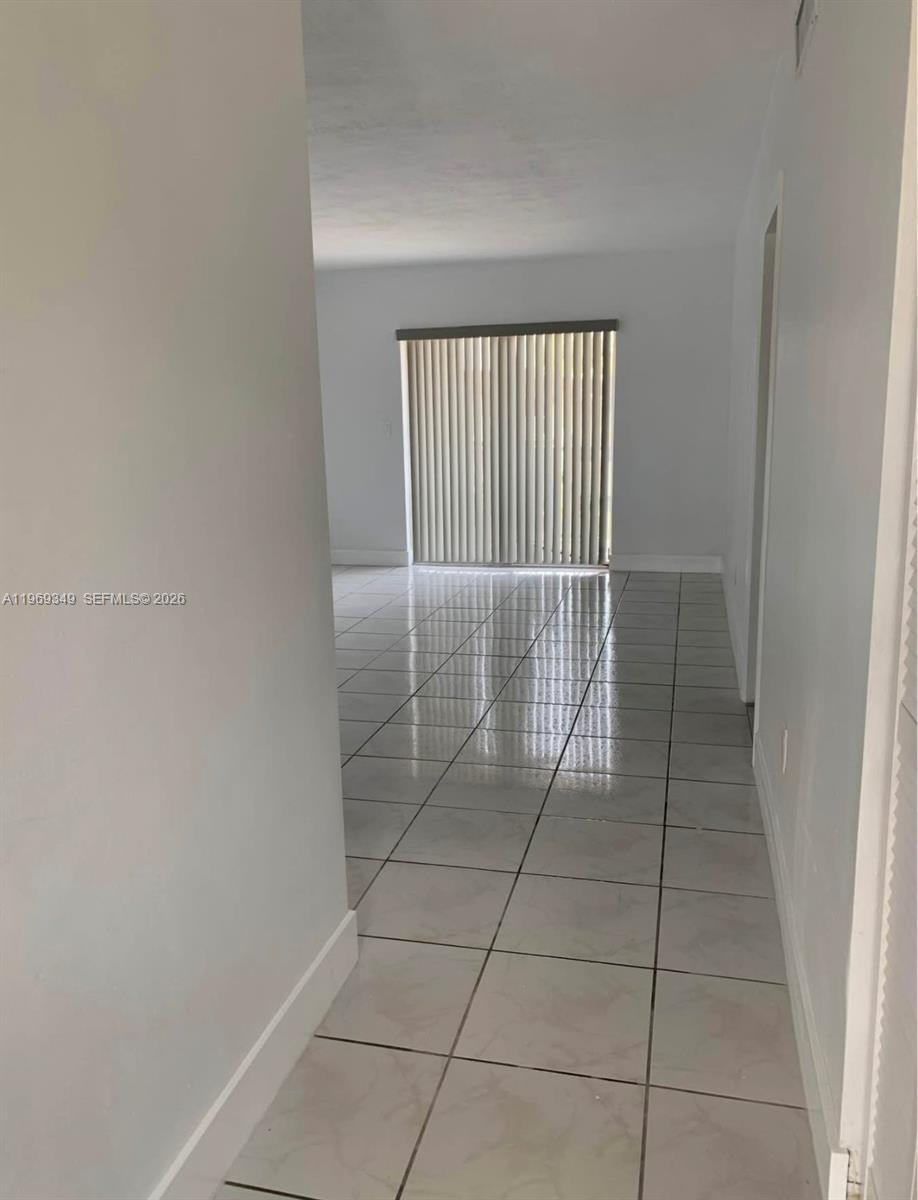 7505 Southwest 82nd Street, Unit 306 Miami, FL 33143 - Photo 4 of 9 a view of empty room with windows