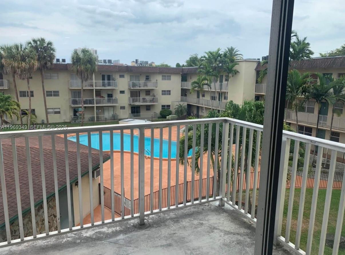 7505 Southwest 82nd Street, Unit 306 Miami, FL 33143 - Photo 8 of 9 a view of a balcony with a floor to ceiling window and wooden fence