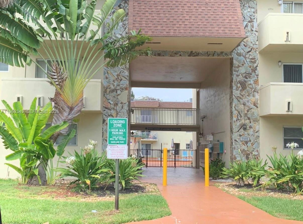 7505 Southwest 82nd Street, Unit 306 Miami, FL 33143 - Photo 9 of 9 a front view of a house with garden