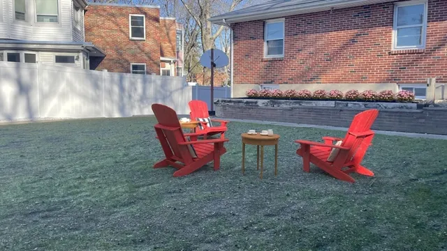 a backyard of a house with outdoor seating