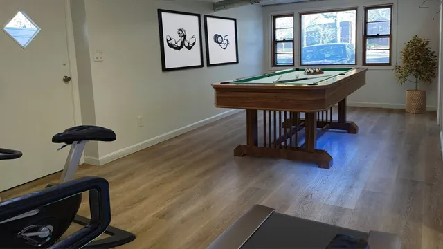 a view of a room with furniture and wooden floor