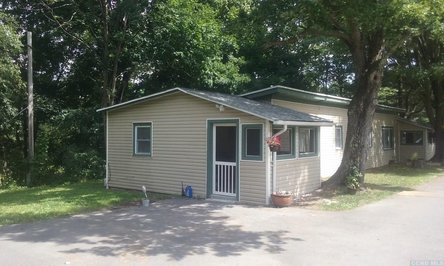 a view of a house with a yard and tree s