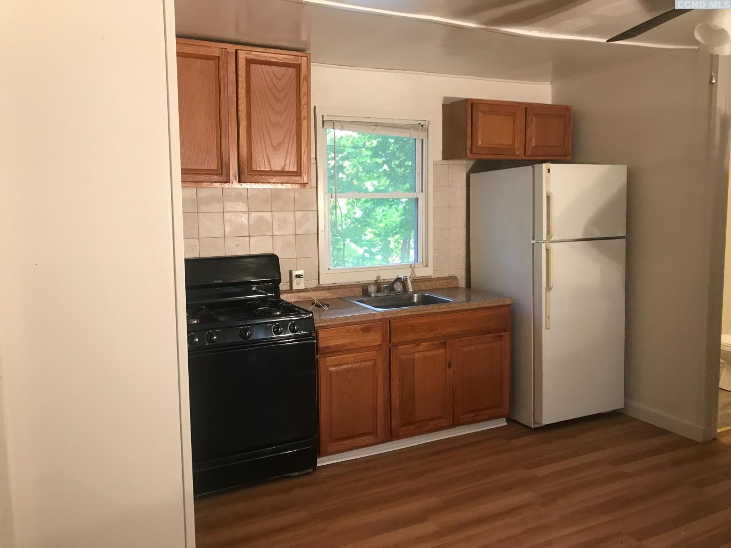 53 Lake Mills Road, Unit 11 Cairo, NY 12413 - Photo 2 of 6 a kitchen with a refrigerator stove and wooden floor