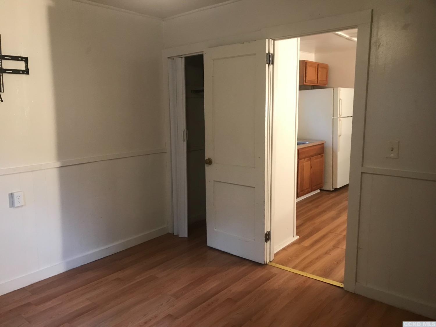 53 Lake Mills Road, Unit 11 Cairo, NY 12413 - Photo 4 of 6 an empty room with wooden floor and a window