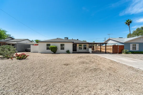 a front view of a house with a yard and a garage