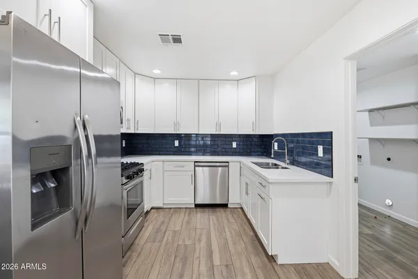 a kitchen with a sink stove and refrigerator