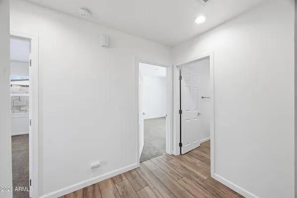 a view of a hallway with wooden floor