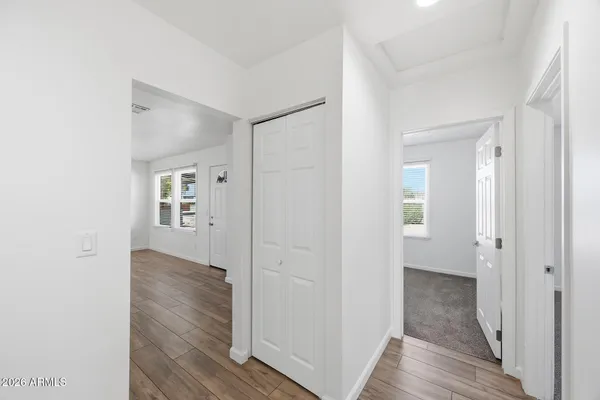 a view of a hallway with wooden floor