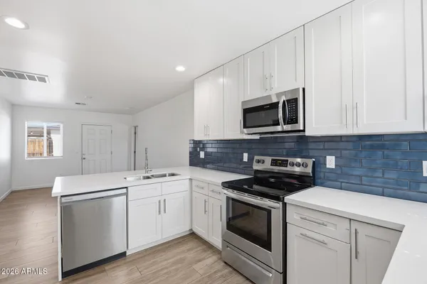 a kitchen with a sink stove and microwave