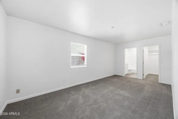 an empty room with a empty space and windows