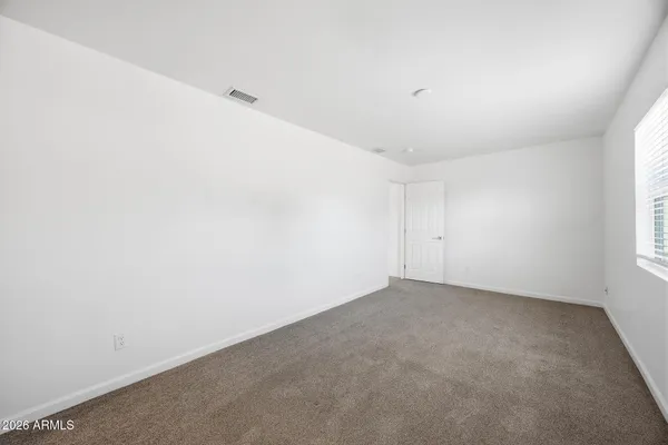 an empty room with a empty space and windows