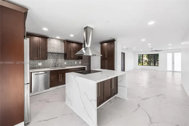 a kitchen with a sink microwave and cabinets
