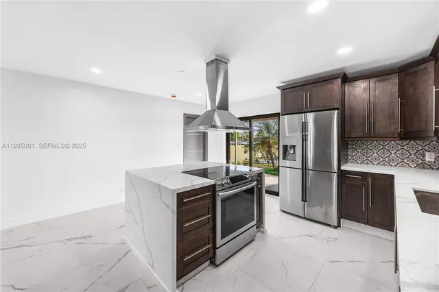 a kitchen with a stove sink and refrigerator