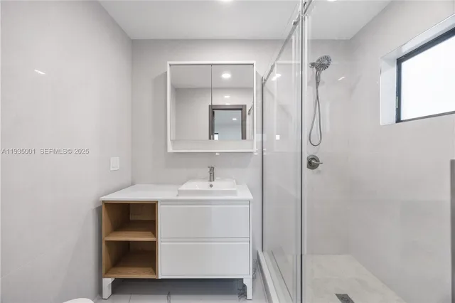 a bathroom with a sink toilet vanity and mirror