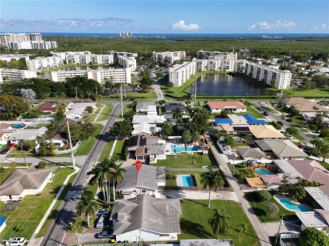 an aerial view of residential building with outdoor space and ocean view