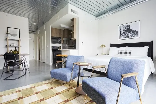 a bedroom with furniture and a rug