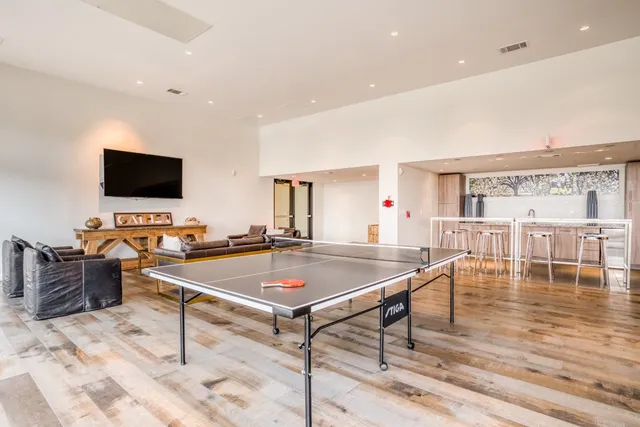 a kitchen with stainless steel appliances a refrigerator and wooden floor
