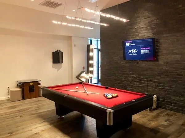 a room with pool table and a flat screen tv