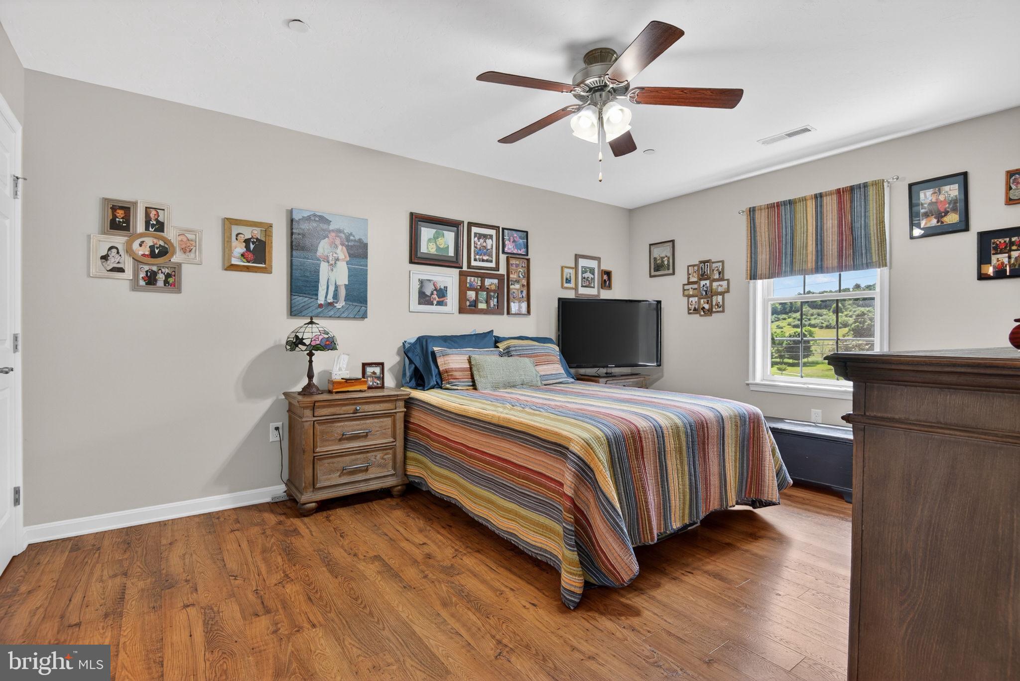 1332 Pleasant View Drive, Unit 75 Spring Grove, PA 17362 - Photo 20 of 26 a spacious bedroom with a bed and a table in it