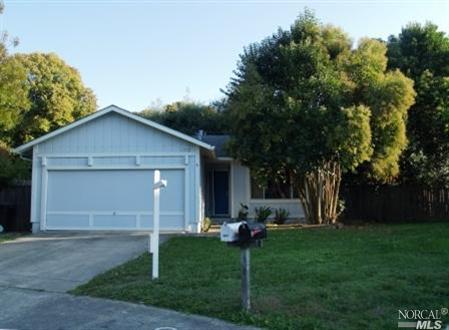 Lush landscaping abounds on this lot with firepit in backyard.