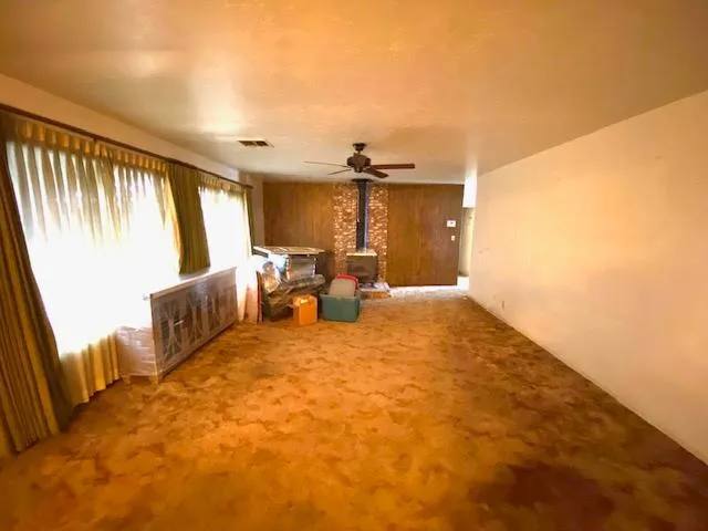 a view of a bedroom with furniture and a window
