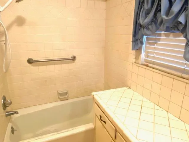 a bathroom with a bathtub and shower