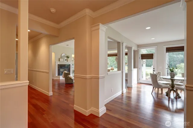 a view of a livingroom with furniture wooden floor and a kitchen