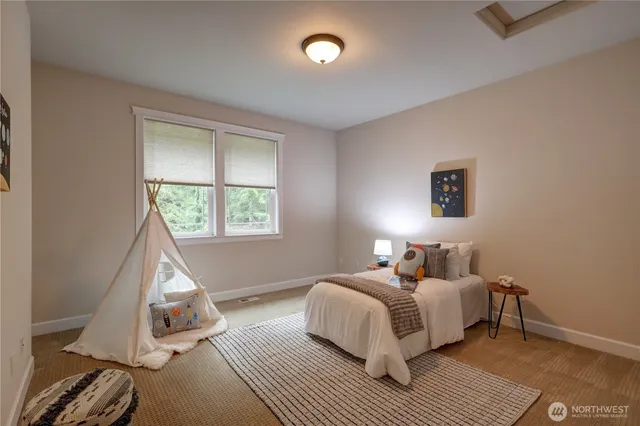 a bedroom with a bed and a window