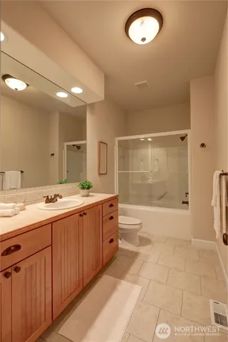 a bathroom with a double vanity sink a large mirror and a shower