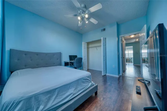 a bedroom with a bed and a chandelier