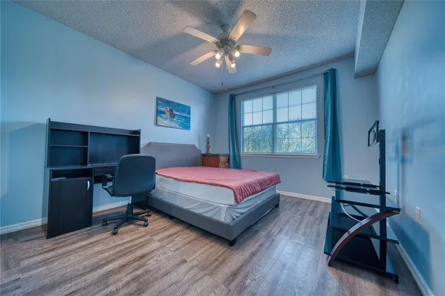 a bedroom with a bed a desk and chair